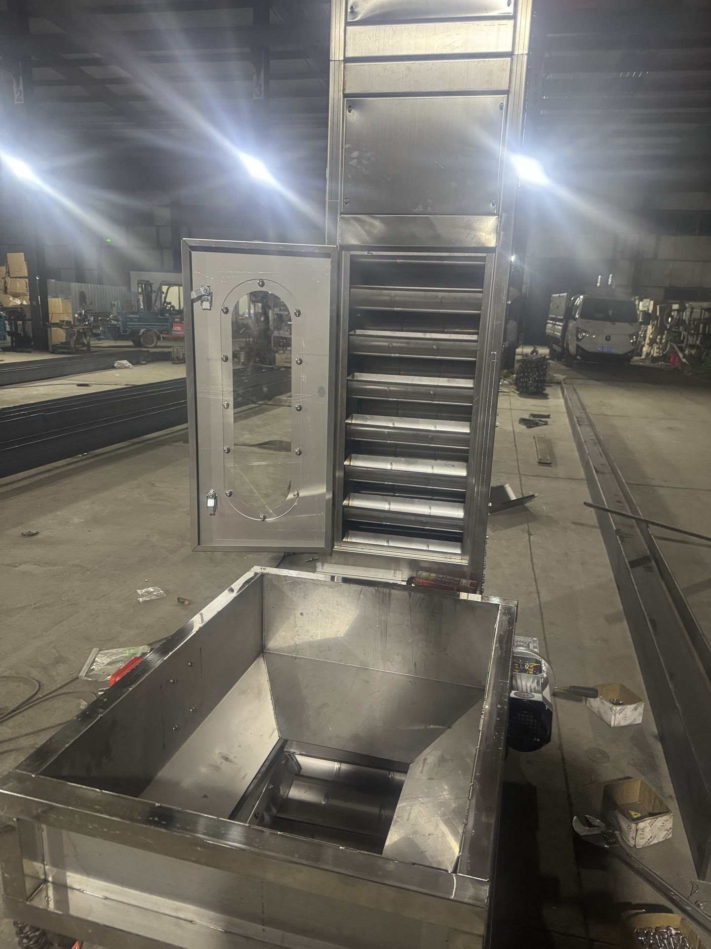 PENKOR vertical lifting conveyor — a bucket elevator with an inlet hopper at its base (bucket-elevator form)