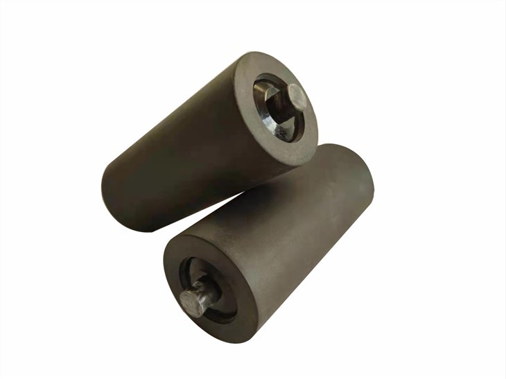 Two composite conveyor idler rollers with hex through-shafts, white background (third-party reference photo)