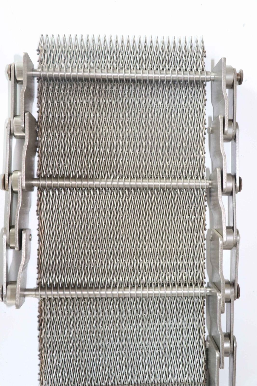 Stainless-steel herringbone (dutch-weave) mesh belt with chain edges (supplier-labelled, higher-res) (third-party reference photo)