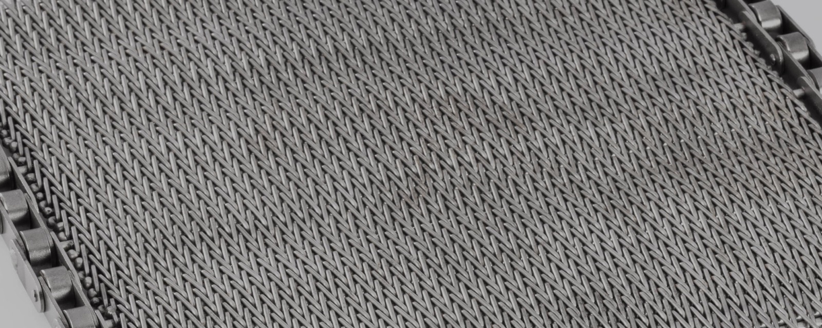 Close-up of a fine stainless-steel woven mesh belt (diagonal/balanced weave) (third-party reference photo)