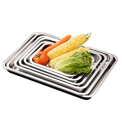 Nested stainless-steel flat trays (sheet-pan type) with vegetables (third-party reference photo)
